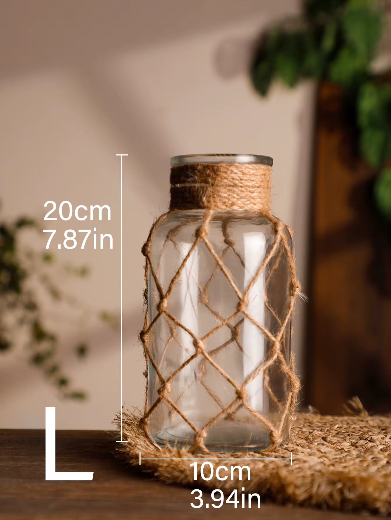 A hand‑woven hemp rope glass vase — a clear glass vessel wrapped in natural hemp fiber. Perfect for dried flowers, it adds texture and warm, rustic charm. Ideal for boho, Nordic, or minimalist interiors.