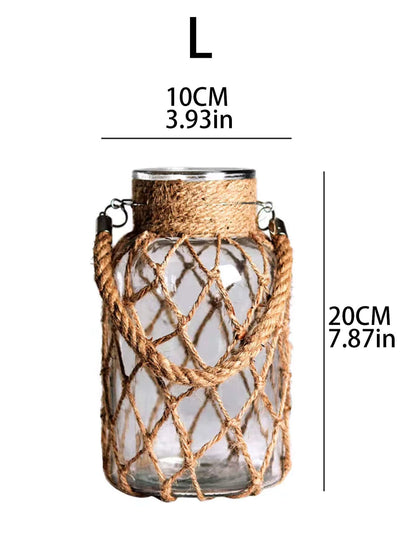 A hand‑woven hemp rope glass vase — a clear glass vessel wrapped in natural hemp fiber. Perfect for dried flowers, it adds texture and warm, rustic charm. Ideal for boho, Nordic, or minimalist interiors.