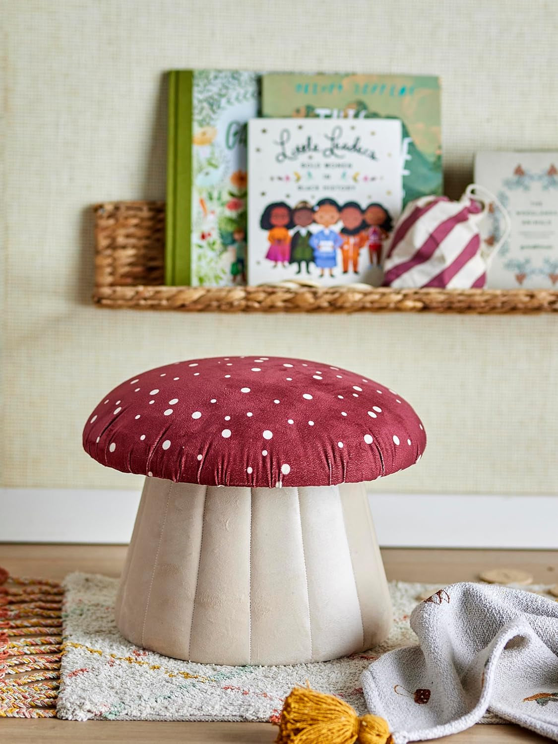 A mushroom-shaped kids’ seat with a soft red polka dot cover and a sturdy MDF base. Perfect as a footrest or extra seat.